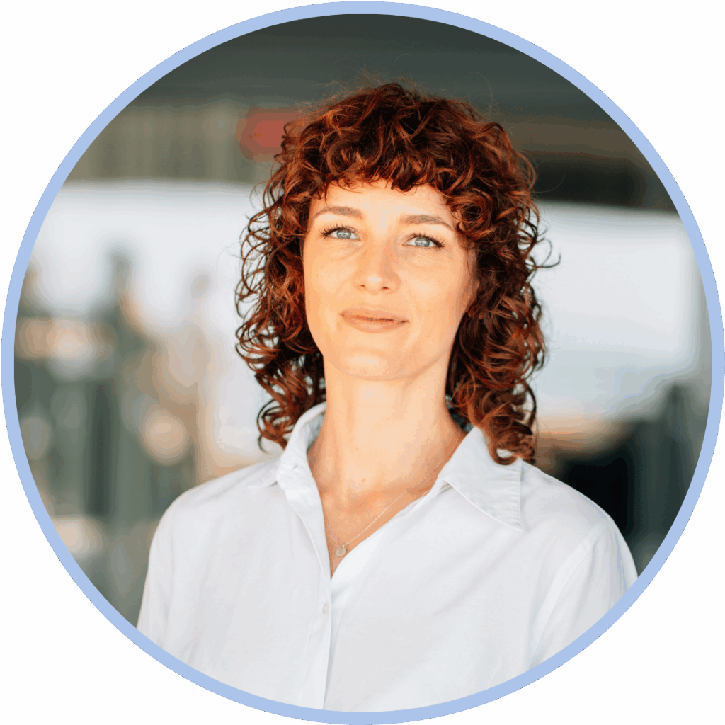 White woman with red hair smiling