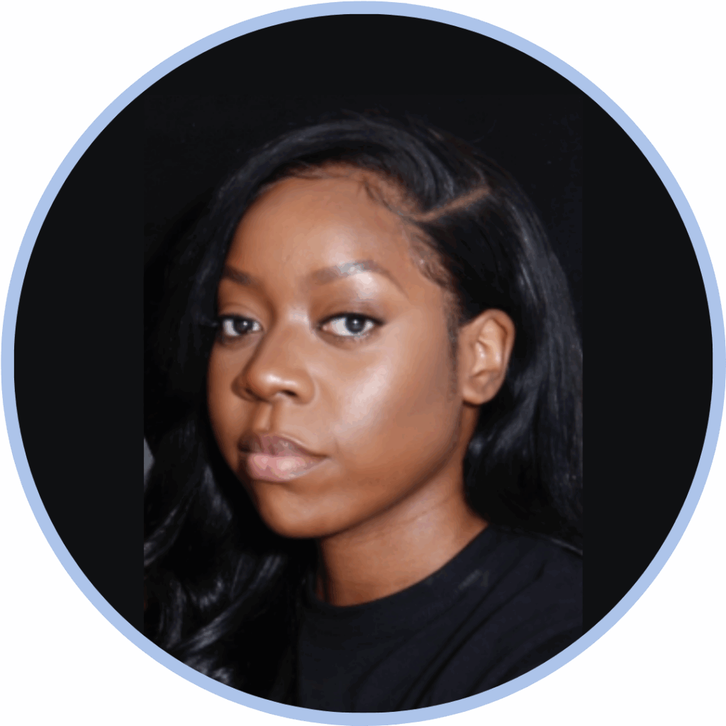 Headshot of a black woman with black hair looking to camera