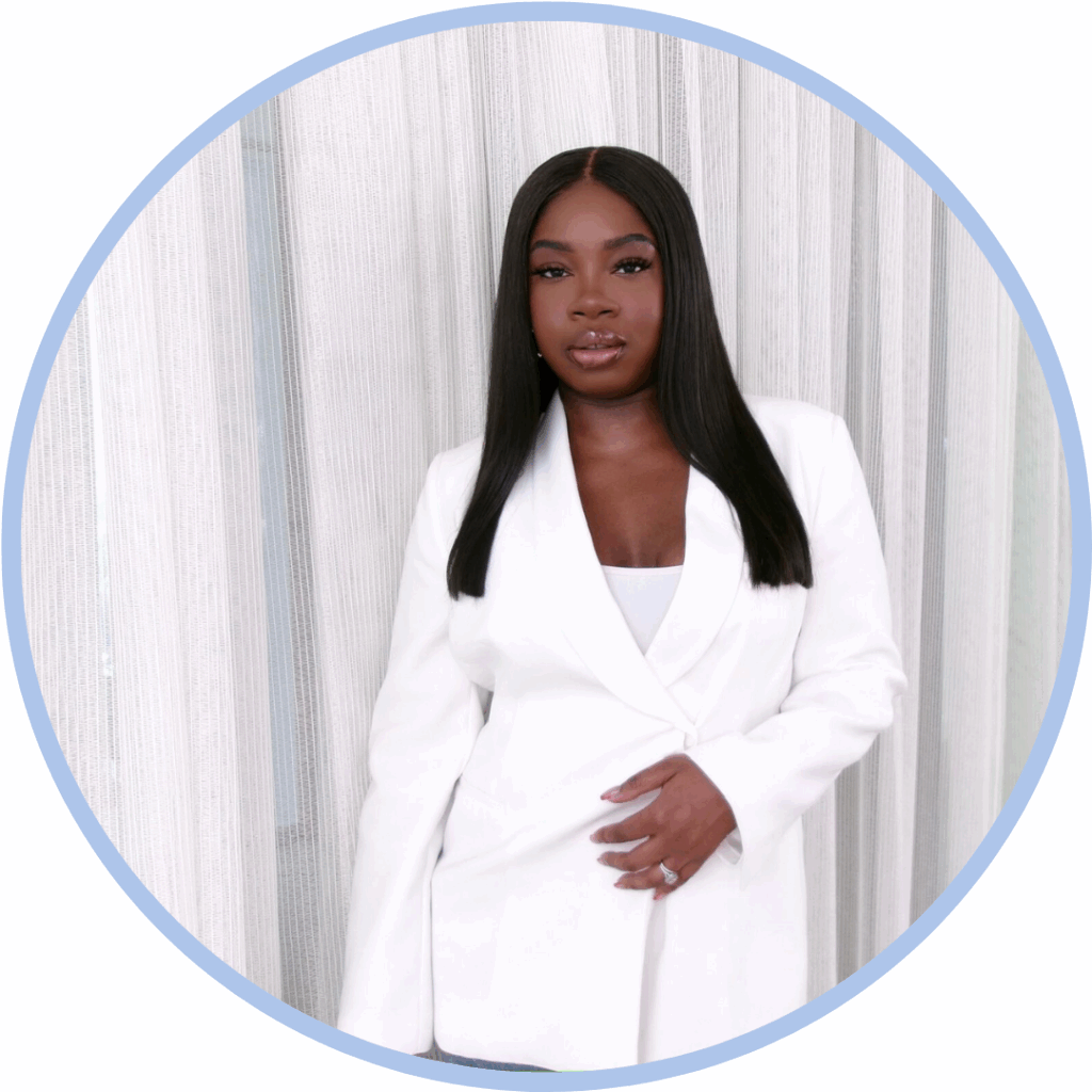 A black woman with black hair wearing a white suit