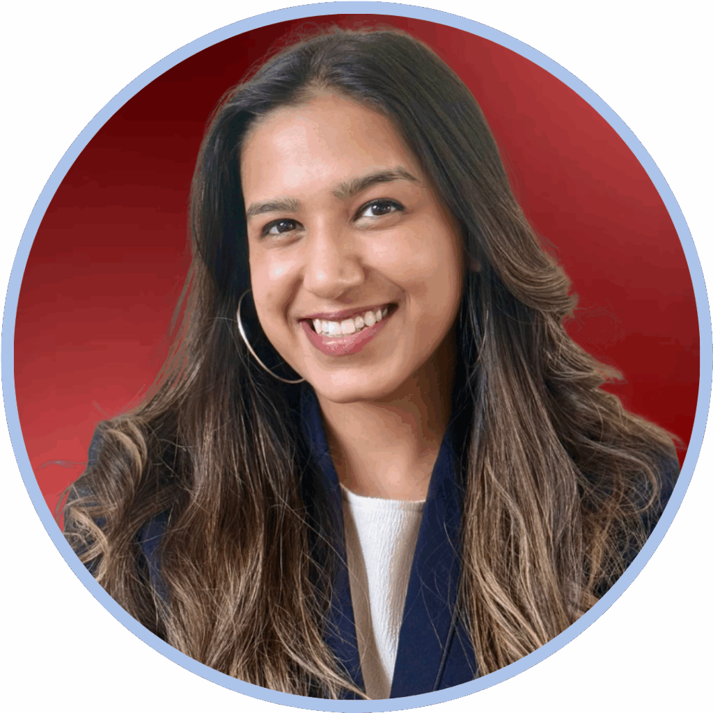 Headshot of an asian woman with long brown hair smiling to camera in front of a red background